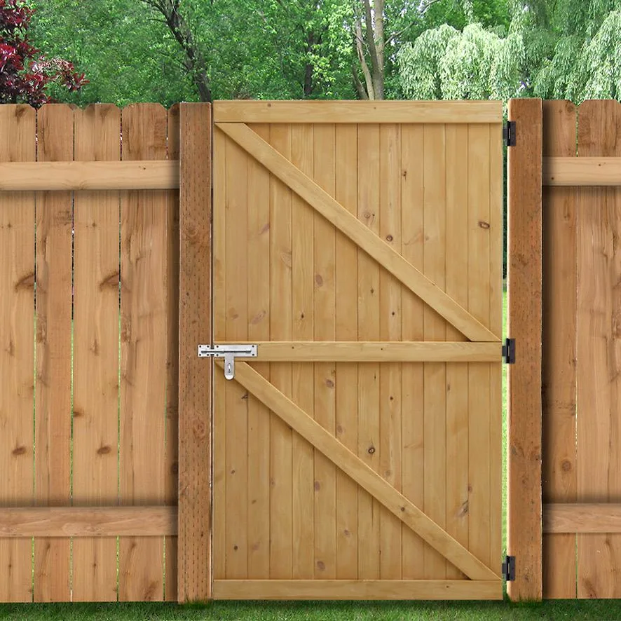 Custom wooden gate fitted within a privacy fence, view 1